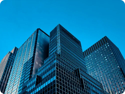 Glass office towers against a blue sky