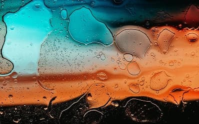 Water droplets on glass in teal and orange light