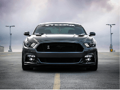 A dark sports car parked on an open road
