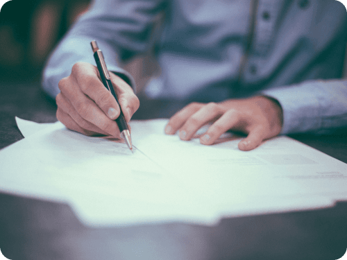 A person reading and signing a policy document
