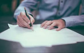 A person reviewing and signing documents