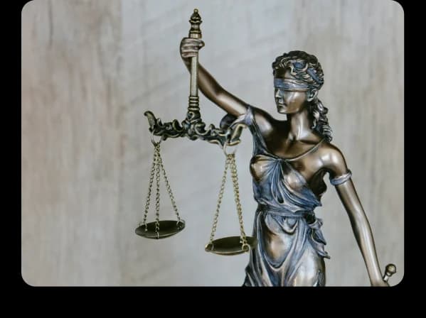 A bronze statue of Lady Justice holding scales