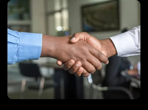 Two people shaking hands in an office