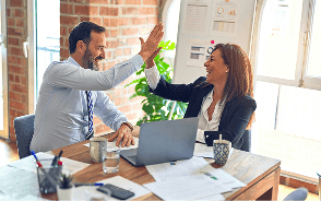Two colleagues celebrating with a high five