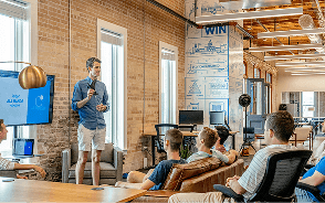 A team listening to a presentation in an office