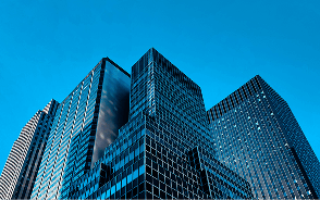 Glass office towers against a blue sky
