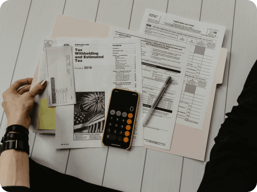 Insurance paperwork and a calculator on a desk