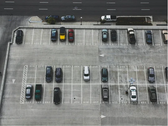 An aerial view of cars parked on an open parking deck