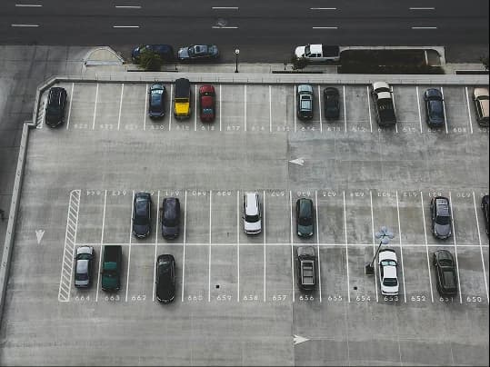 An aerial view of cars parked on an open parking deck