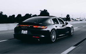 A black Porsche Panamera driving on a motorway