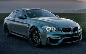 A grey sports saloon parked outside