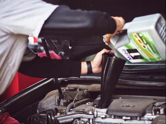 A mechanic working on a car engine